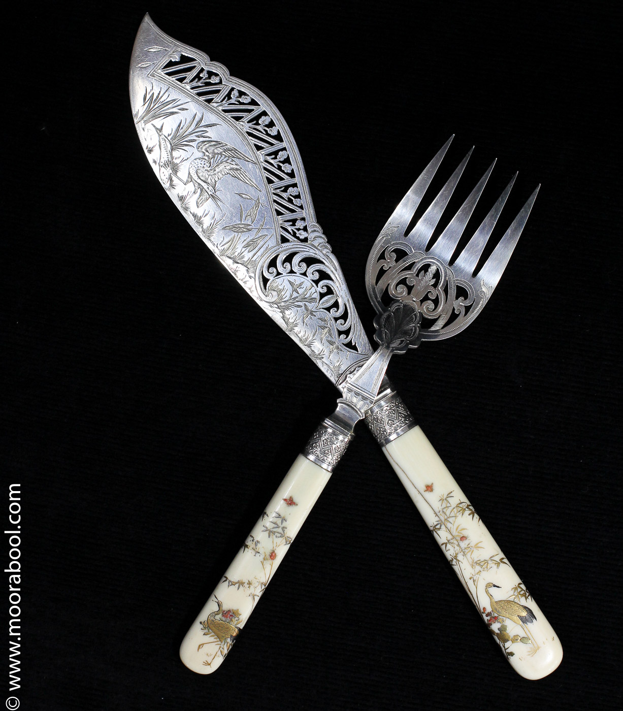 Pair of Japanesque fish servers, lacquered ivory handles & finely pierced & engraved blades, c. 1885-0