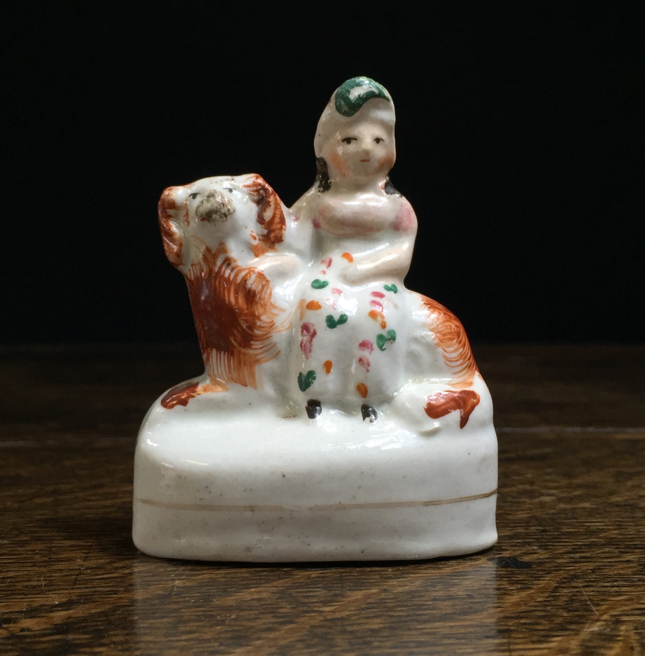 Staffordshire miniature figure, girl on spaniel, c.1850-0