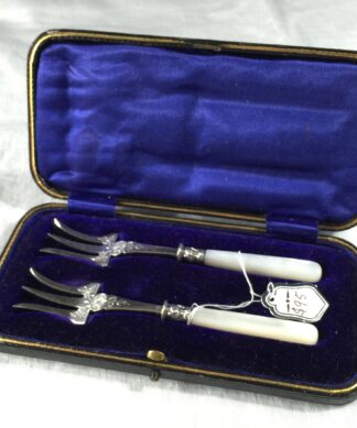 Two pearl handled pickle forks, c. 1890-0