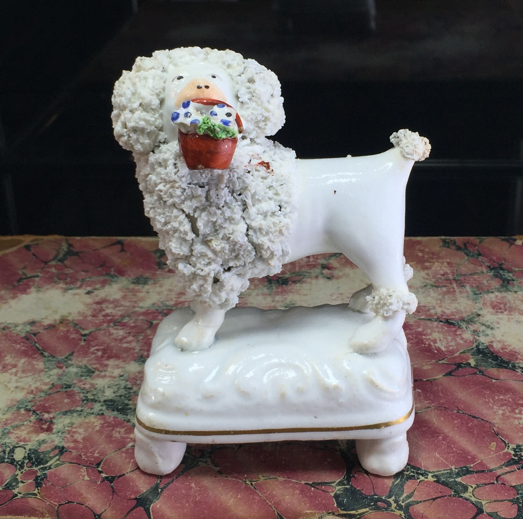 Staffordshire porcelain poodle with basket on high base, c. 1835-0