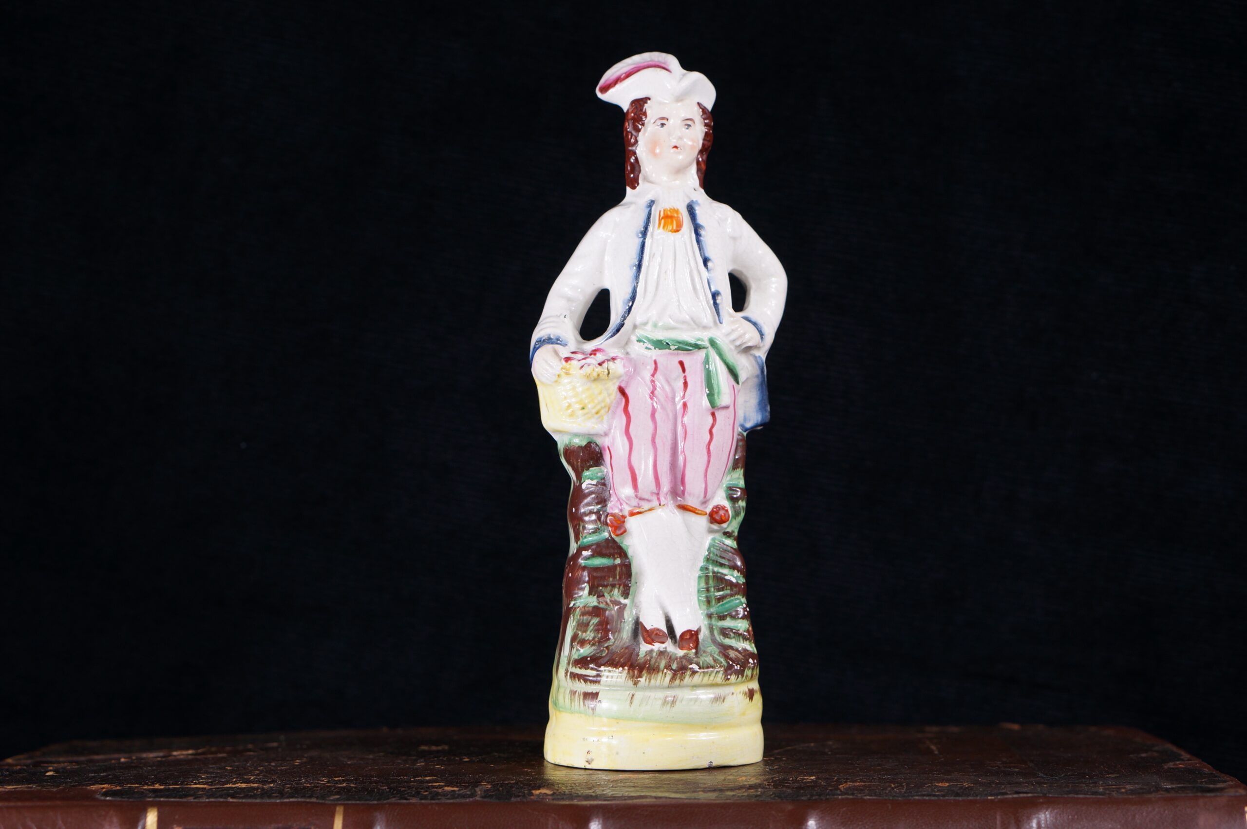 Staffordshire pottery figure, man with a basket, c.1860-0