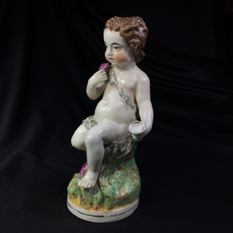 Staffordshire figure of a seated Bacchanalian child, c. 1850 -0