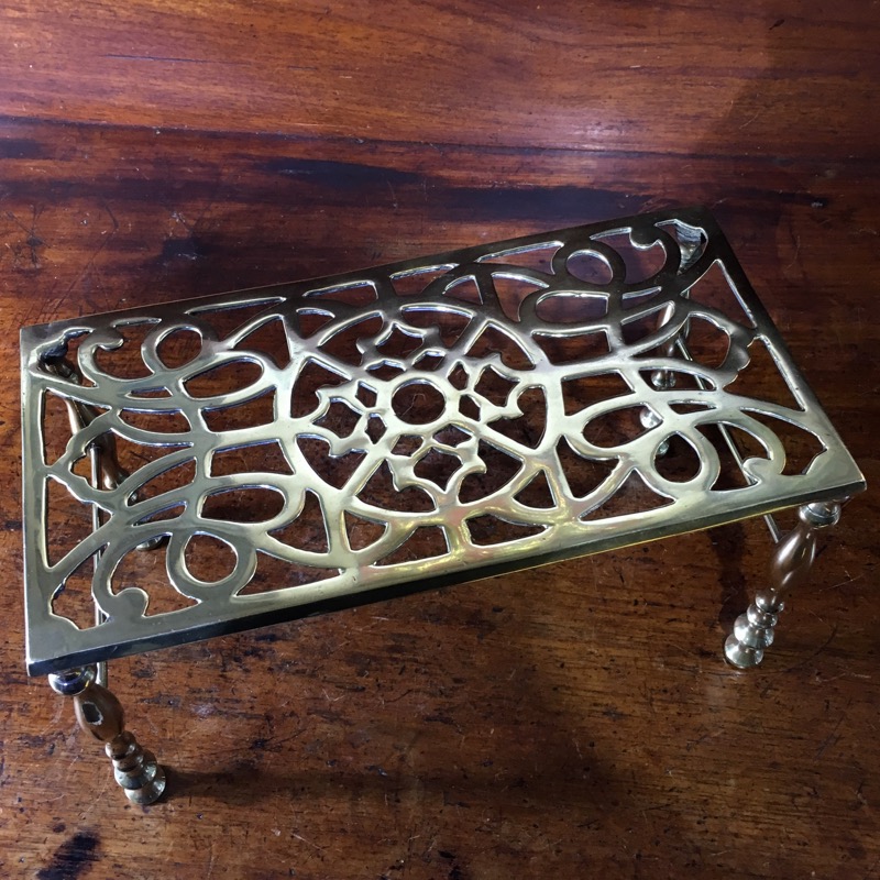 Georgian brass trivet, with four legs, pierced top, c.1800-0