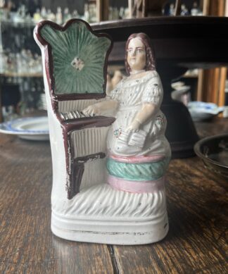 Staffordshire figure, girl with piano, c. 1860