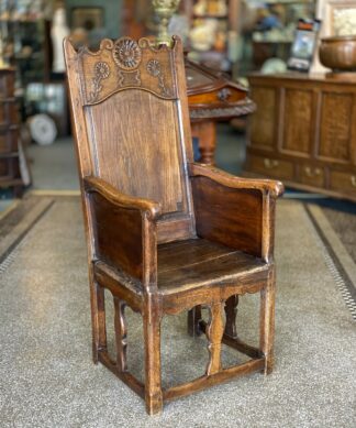 French joined armchair, paneled sides, flower carved crest & dated 1778