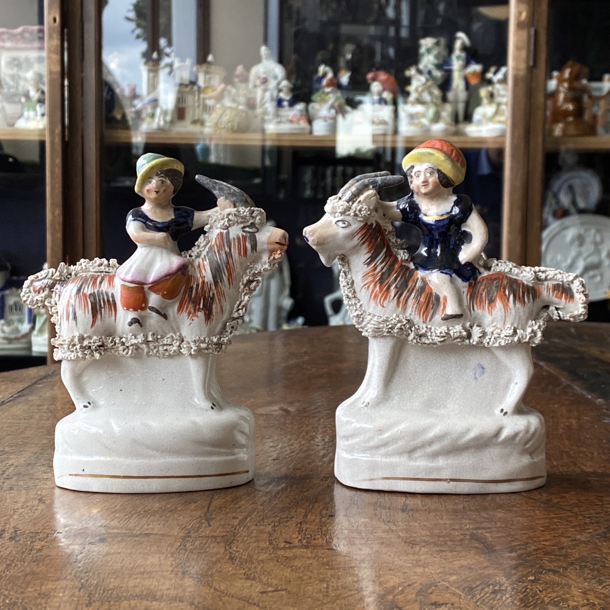 Pair of Staffordshire children on goats circa 1855