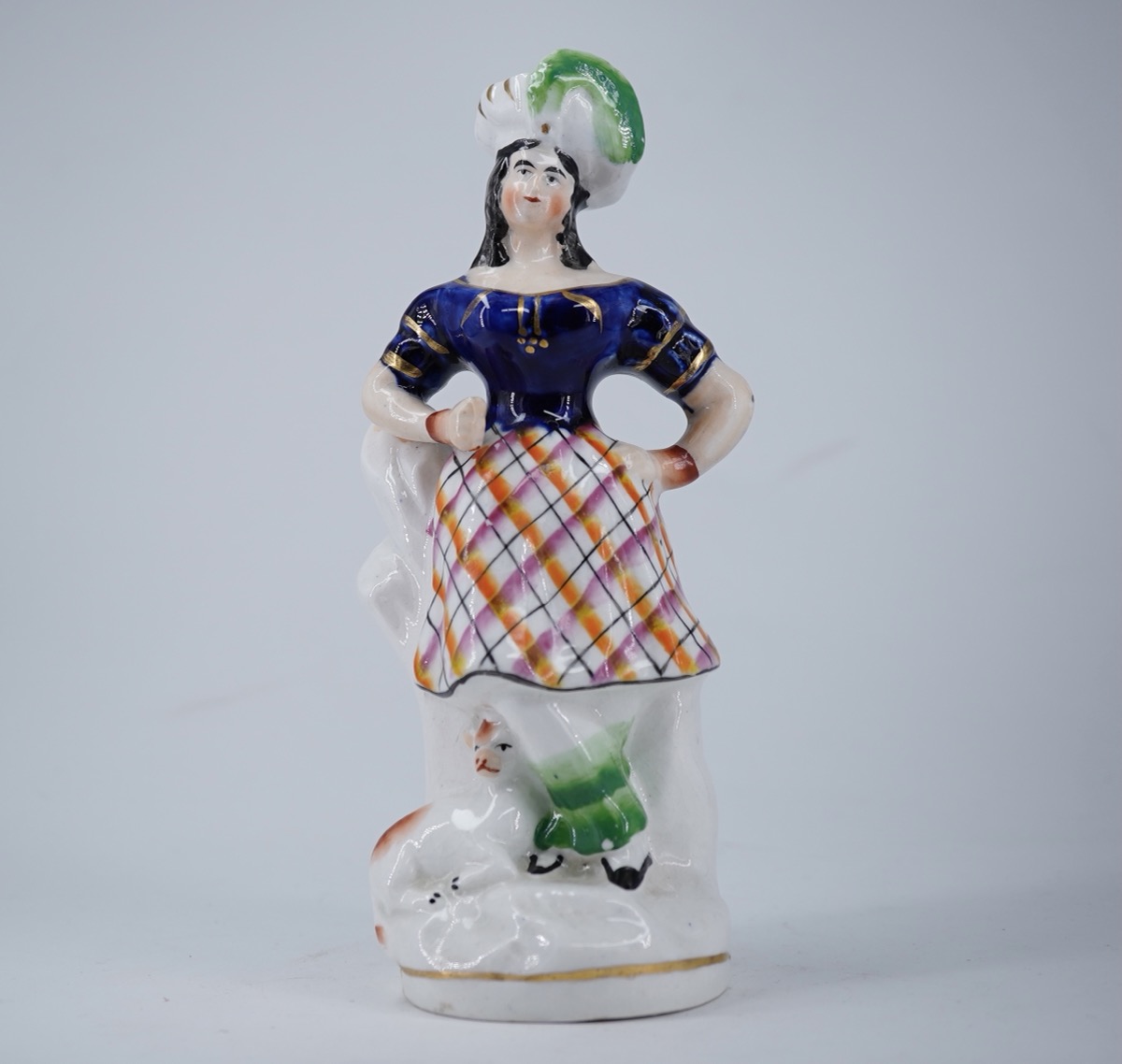 Staffordshire figure of a Scottish lady in a feathered hat, sheep at feet,c.1855