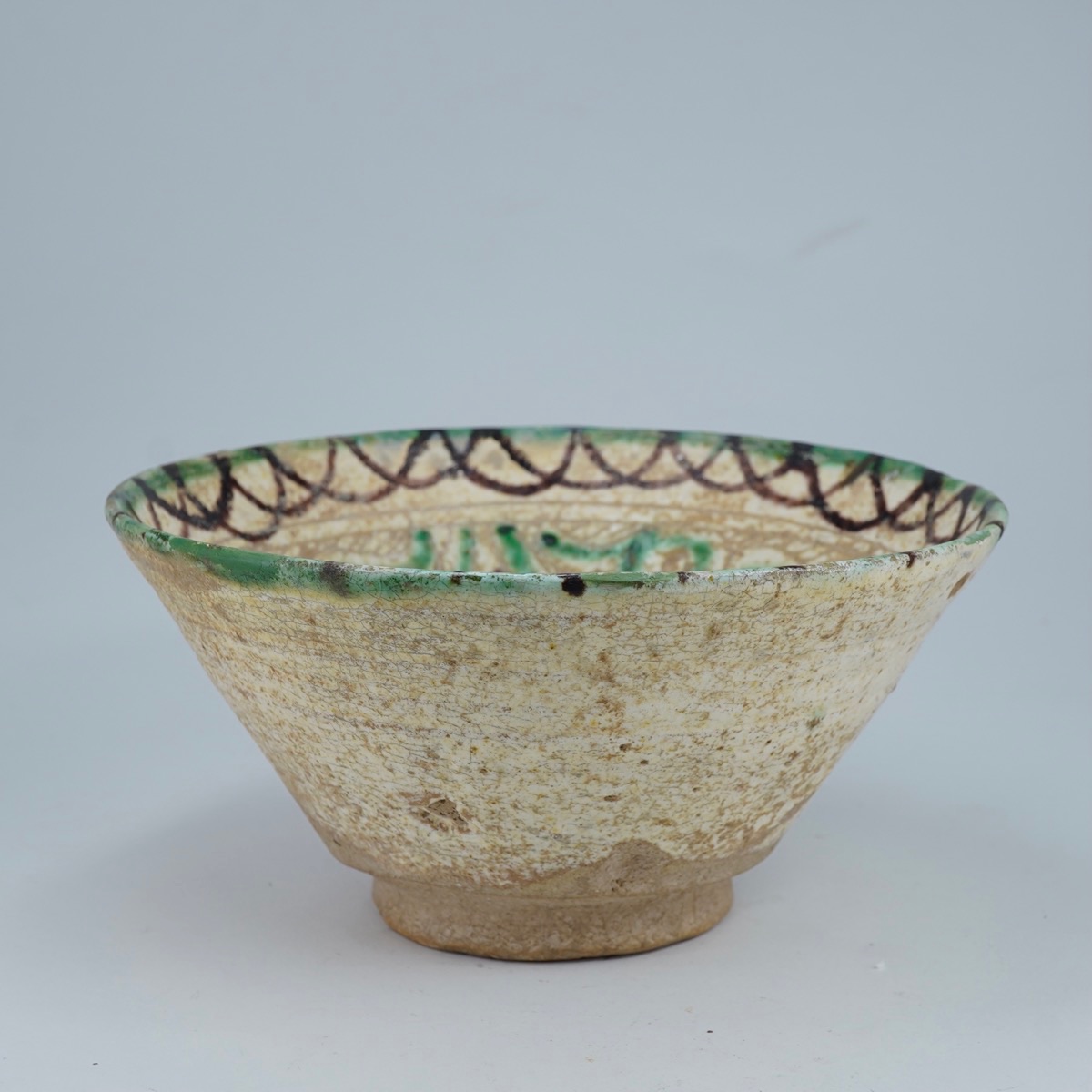 Islamic Bamiyan type Scraffito bowl, green, brown & cream slip, 12th century