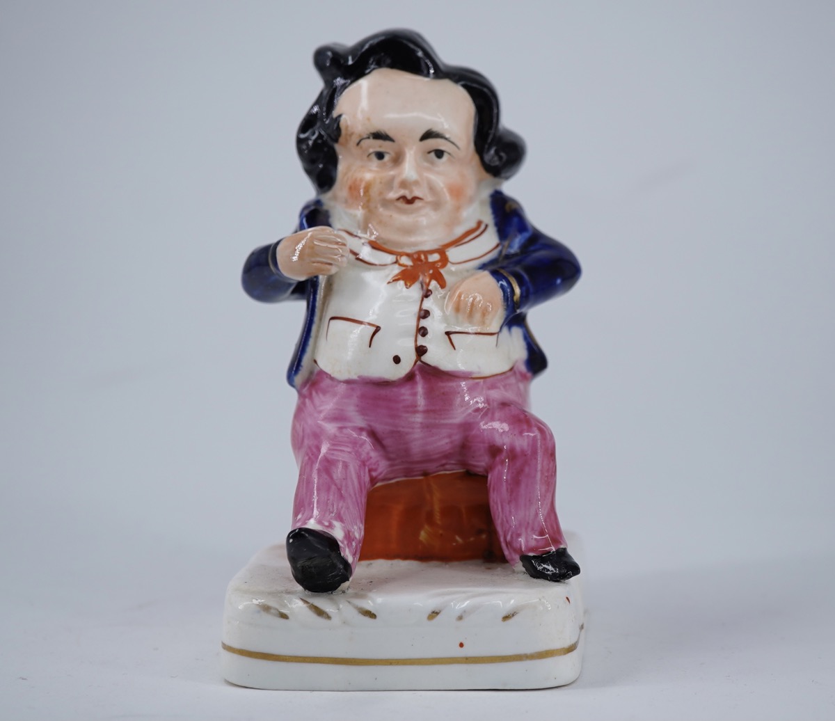 Staffordshire porcelain comical seated figure, c. 1850