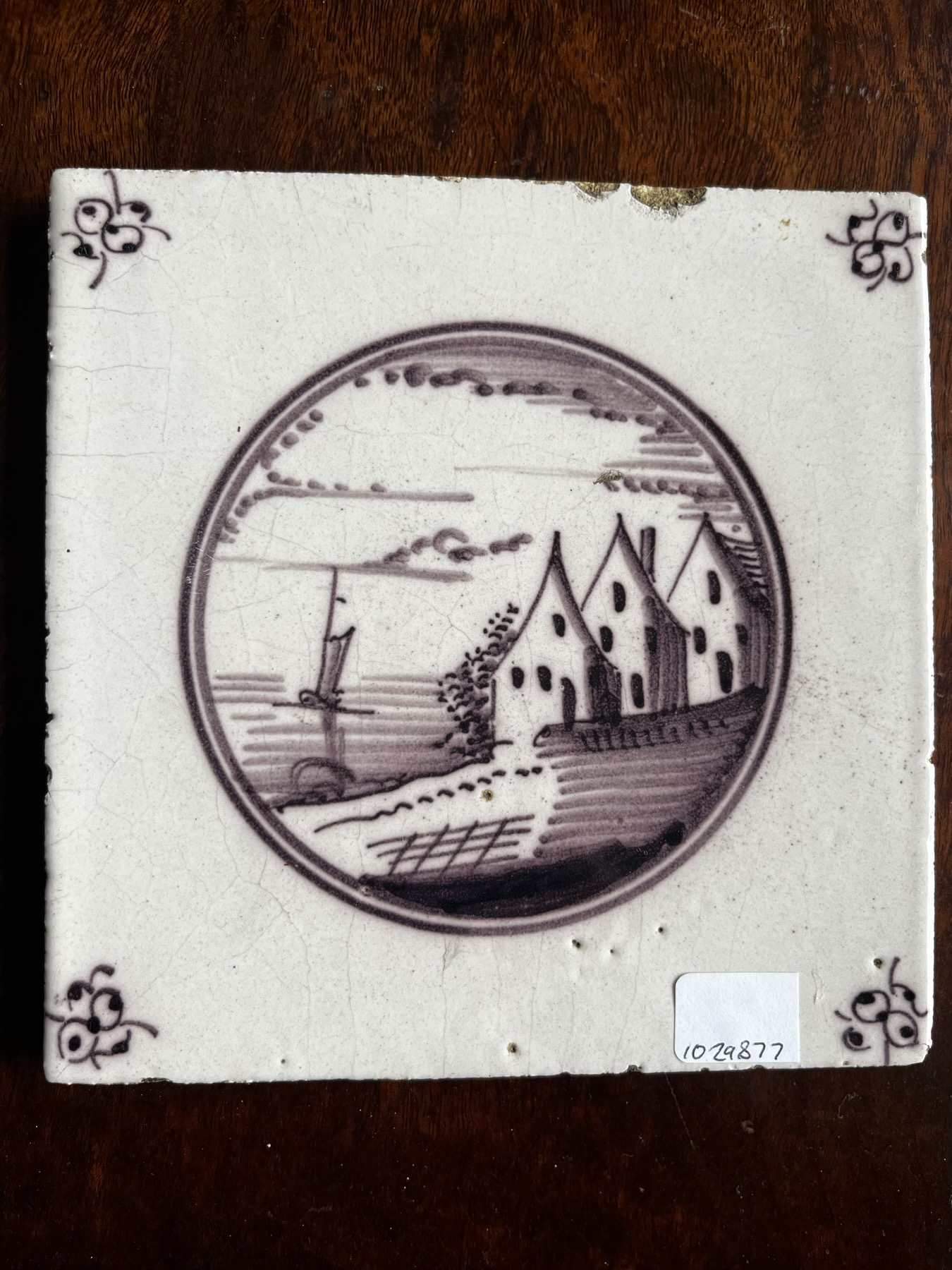 Dutch Delft manganese tile, houses by the sea, c. 1800