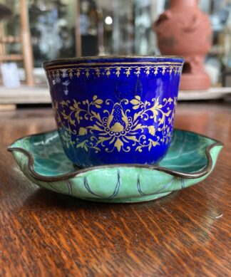 Chinese enamel cup in lotus leaf stand, 18th century