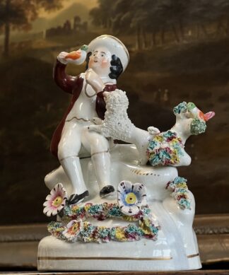 Staffordshire pottery figure, boy with birds, nest & dog, C.1830