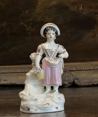 Staffordshire porcelain figure of a flower girl, c. 1830