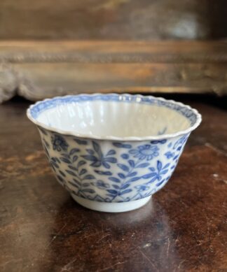 Kanxi moulded tea bowl, underglaze flower garden, rabbit mark c. 1720