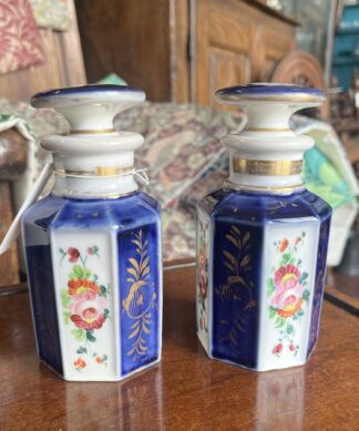 Pair of blue and white decanters painted with flowers