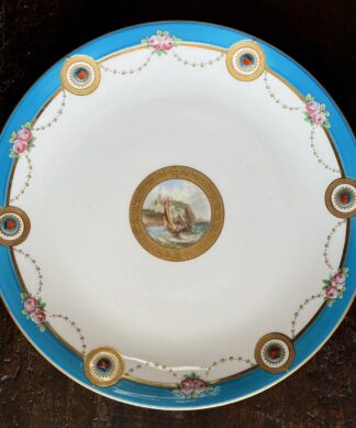 Minton plate with central landscape, turquoise rim with ladybugs, dated 1873