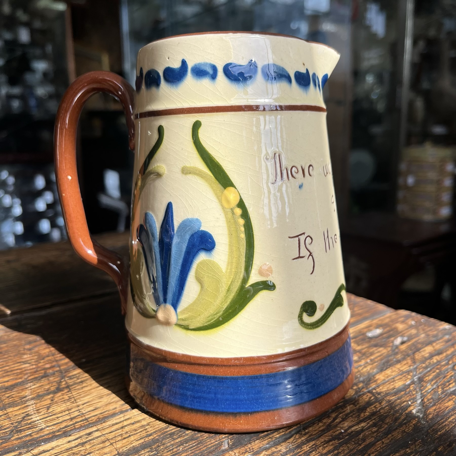 Torquay Longpark Pottery 'Tormohun' jug, 'There would be no shadows If the sun were not shining' c. 1920's