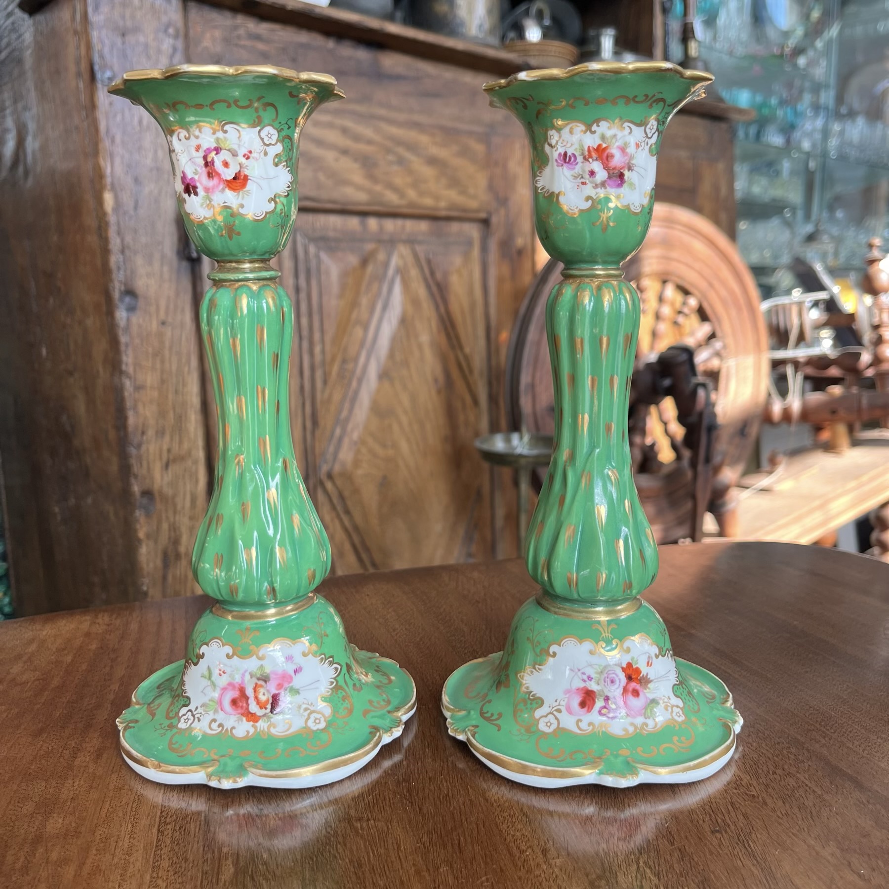 Pair of porcelain candlesticks, green with flowers, c.1830