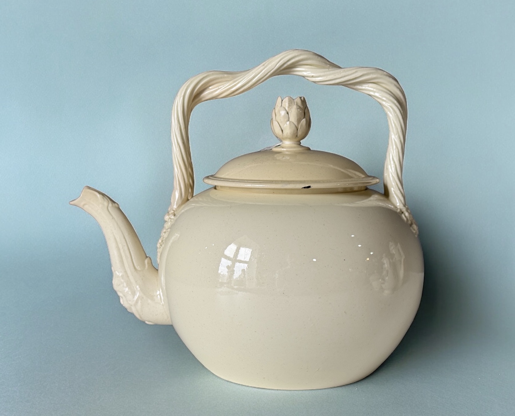 Creamware punch pot / tea kettle with baroque face & double strap handle, English c. 1780