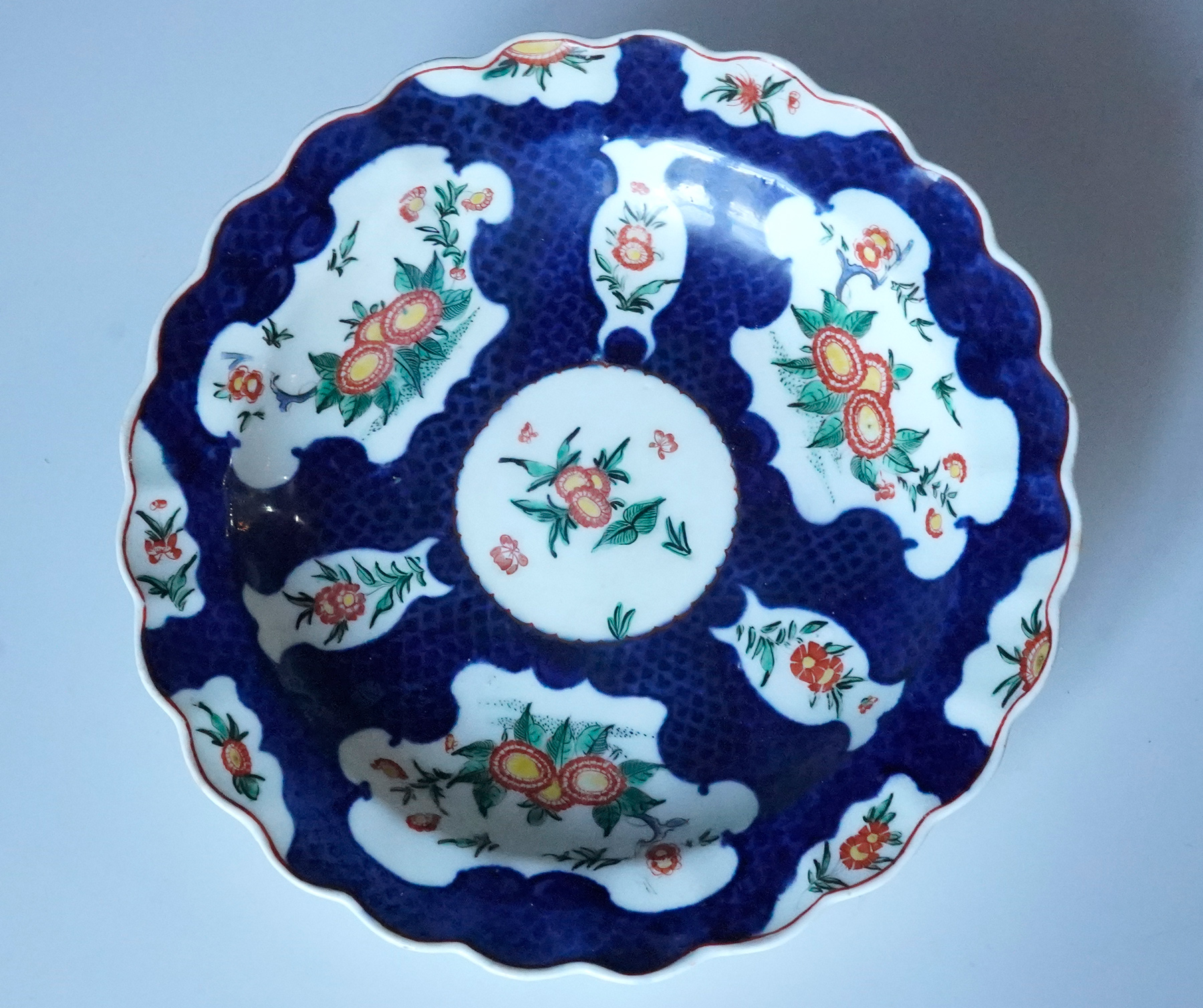 Worcester 'Red Line' group plate, scale blue & oriental flowers, c. 1770